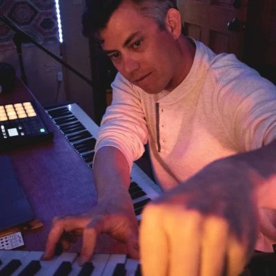 John Hayes playing keys in the studio