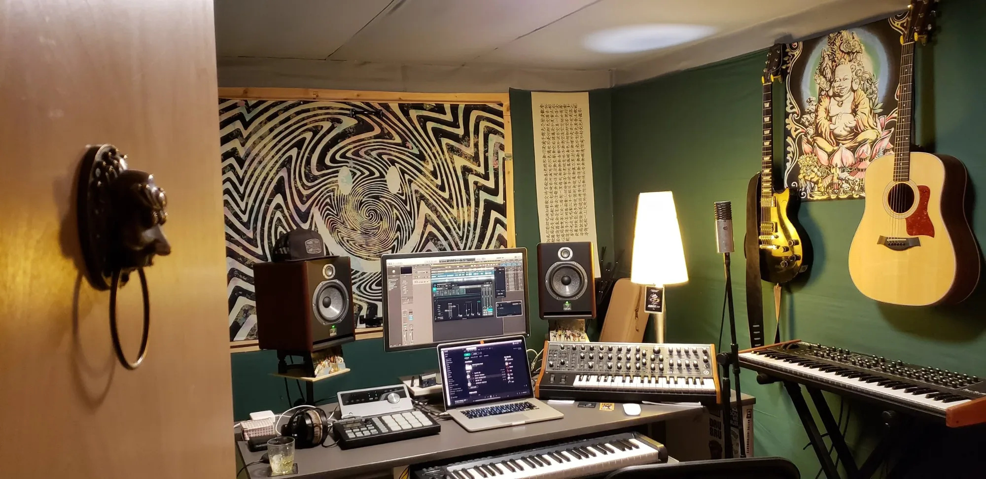 The previous custom-built production and mixing studio, with monitors, synths and guitars